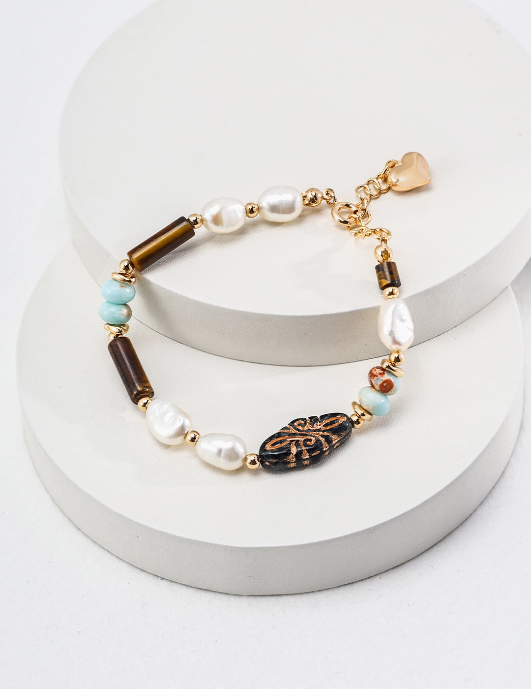 A vintage-inspired bracelet featuring Shoushan stone, tiger eye beads, and freshwater pearls.