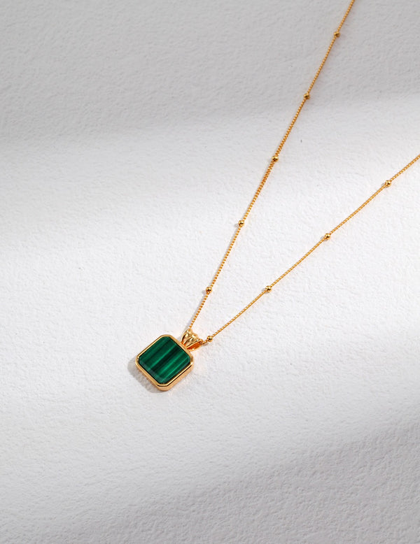 Gold vermeil necklace with a square malachite pendant, featuring a sleek design and adjustable chain.