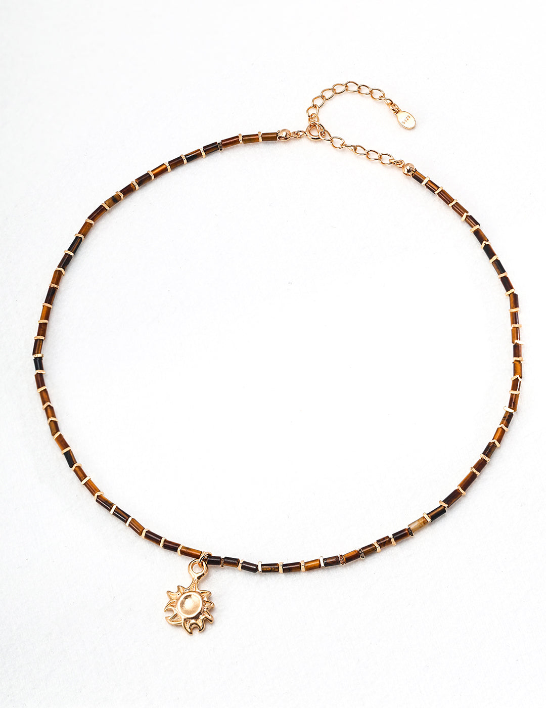 Tiger eye beaded necklace with a radiant gold sun pendant, combining warm earth tones and elegant design.